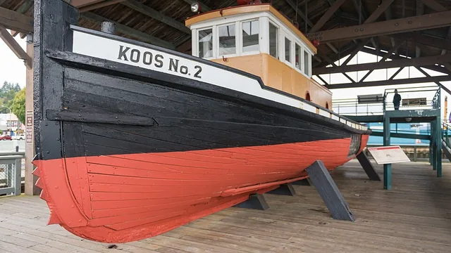 The historic tugboat Koos No. 2 on display under a timber shelter